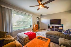 a living room with a couch and a flat screen tv at 2 Mi to Pewaukee Lake! Peaceful Retreat with Yard in Pewaukee