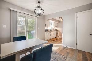 a kitchen and dining room with a table and chairs at 2 Mi to Pewaukee Lake! Peaceful Retreat with Yard in Pewaukee