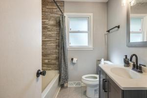 a bathroom with a sink and a toilet and a window at 2 Mi to Pewaukee Lake! Peaceful Retreat with Yard in Pewaukee +21 photos