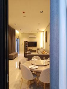 a dining room and living room with a table and chairs at اجواء الريف لبيوت العطلات in Dammam