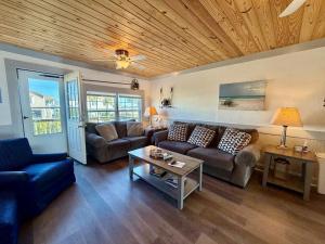 a living room with a couch and a table at Canal front home on 3rd St. in Surf City, NC in West Onslow Beach