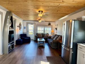 a living room with a couch and a refrigerator at Canal front home on 3rd St. in Surf City, NC in West Onslow Beach