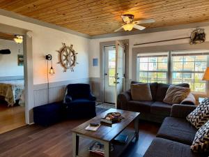 a living room with a couch and a table at Canal front home on 3rd St. in Surf City, NC in West Onslow Beach