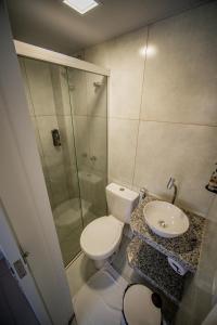 a bathroom with a toilet and a sink and a shower at Amazinn Hotel in Belém