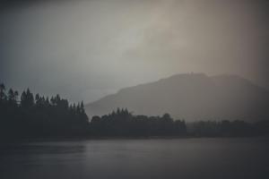 a misty view of a mountain and a lake at NICHT' Apartments Inveraray Town Centre in Inveraray +3 photos