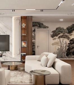 a living room with a white couch and a tv at Louise Delux- Free privat parking in Nyíregyháza