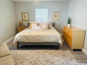 a bedroom with a bed with pillows and a dresser at Siesta Key Beach House in Siesta Key