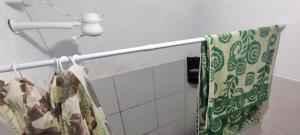 a towel hanging on a towel rack in a bathroom at Shantti House in Pipa +9 photos