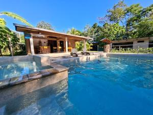 a swimming pool in front of a house at MAYU PATANPI Amazon Lodges in Tarapoto