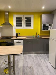 a kitchen with yellow walls and a counter top at Le belair in Le Diamant