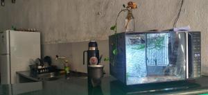 a counter top with a tv on a table at Shantti House in Pipa