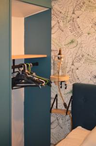 a room with a bed and a lamp on a wall at A L ESCALE PASSA PAÏS in Le Poujol-sur-Orb