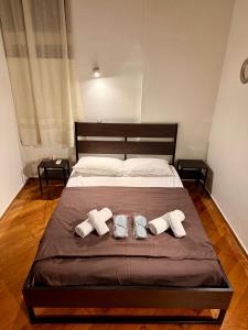 a large bed with two towels and two shoes on it at Blue Note in Mytilini