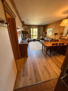 a living room with a table and a couch at Grande Marmotte, Ski aux pieds, Le Refuge du Montagnard, Arc 1950 in Bourg-Saint-Maurice