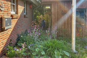 een tuin met bloemen voor een huis bij Elkjer 24 in Großenwiehe