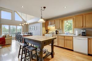 a kitchen with wooden cabinets and a table and chairs at Four Seasons Chalet in Waterbury Center
