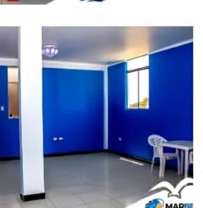 a room with blue walls and a table and a chair at Descubre un lugar pensado para ti in Sechura