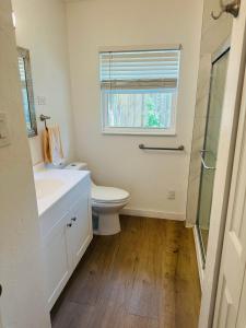 a bathroom with a toilet and a sink and a window at Siesta Key Beach House in Siesta Key +19 photos