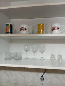 a row of wine glasses on a shelf at Milica Apartmani in Vrdnik +26 photos