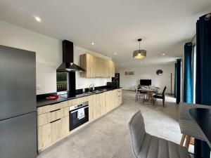 a kitchen and dining room with a table and chairs at Karrika buria in Saint-Martin-dʼArberoue