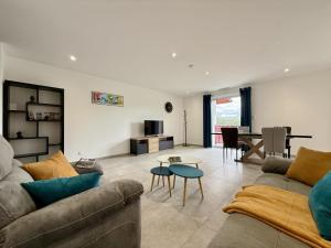 a living room with a couch and a table at Karrika buria in Saint-Martin-dʼArberoue