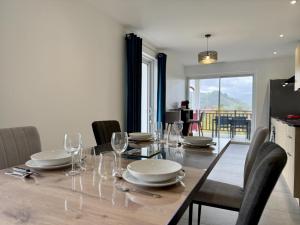 a dining room with a table with glasses and plates at Karrika buria in Saint-Martin-dʼArberoue +19 photos