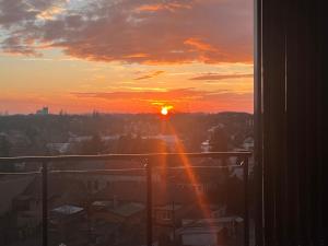 a view of a sunset from a balcony at Louise Delux- Free privat parking in Nyíregyháza