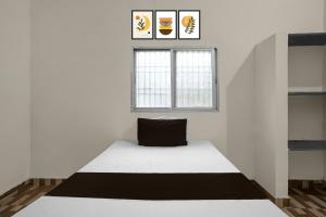 Ένα ή περισσότερα κρεβάτια σε δωμάτιο στο Hotel O Hamar Mitan