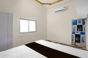 Ένα ή περισσότερα κρεβάτια σε δωμάτιο στο Hotel O Hamar Mitan