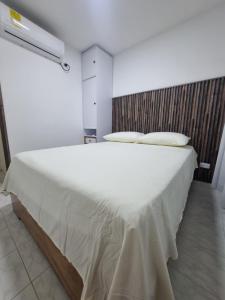 a bedroom with a large white bed in a room at Casa Narad Valledupar in Valledupar +9 photos