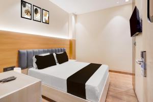 a bedroom with a bed and a television in it at Hotel O Parth in Ayodhya
