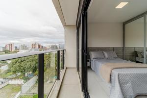 Ένα ή περισσότερα κρεβάτια σε δωμάτιο στο Max Lofts Residencial Flipchave MAX000