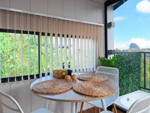 a table with cushions on top of a balcony at FORESTA 2 - Cabaña moderna con vista a la piedra in Chiquinquirá