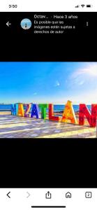 a picture of a colorful wall with the words karma at Hotel Posada Gabriel in Mazatlán