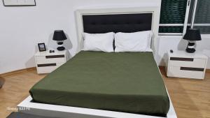 a bedroom with a large bed with two night stands at Vivenda Soalheira in Fajã de Baixo