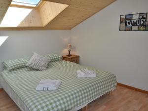 a bedroom with a bed with two towels on it at Appartement spacieux près des pistes avec balcon et parking - FR-1-692-14 in La Chapelle-dʼAbondance