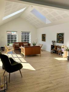 a living room with a couch and a table at Holiday Home With Courtyard In Lille Skagen in Skagen