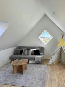 a living room with a couch and a table at Holiday Home With Courtyard In Lille Skagen in Skagen