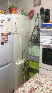 a kitchen with a white refrigerator and a stove at Casa con encanto con perritos in San Juan de Alicante