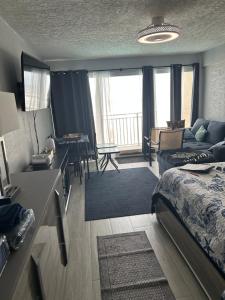 a bedroom with a bed and a living room at Daytona Inn in Daytona Beach