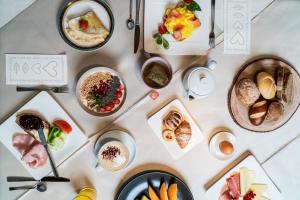 a table filled with different types of food at Hotel COSMEA 4 Stars - Your Dolomites experience in Ortisei