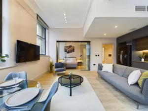 a living room with a couch and a table at Luxury Unique 2bedroom city centre in Manchester