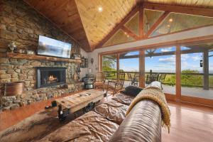 a living room with a couch and a fireplace at Sit Stay Play in Beech Mountain