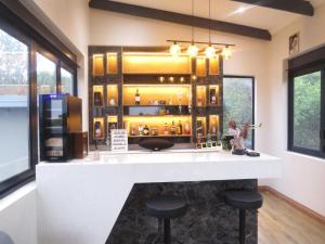 a kitchen with a bar with stools in a room at Thaba Bosiu Villa in Naboomspruit