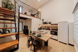 a kitchen with a table and a white refrigerator at Compact Loft Residencial Flipchave CLO000 in Boa Vista