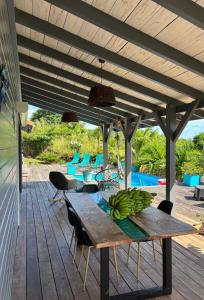 a wooden table with bananas on a deck at Bel Kay in Rivière-Salée