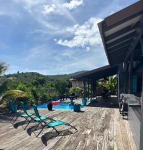 a patio with chairs and a swimming pool on a house at Bel Kay in Rivière-Salée