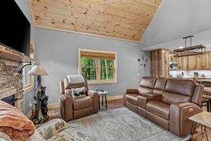 a living room with a couch and a chair at Bear Necessities in Beech Mountain