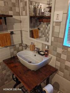 a bathroom with a white sink on a wooden table at Habakkuk Guesthouse in Bethlehem +62 photos