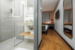 a bathroom with a sink and a shower at ibis Navegantes Itajai in Itajaí +43 photos